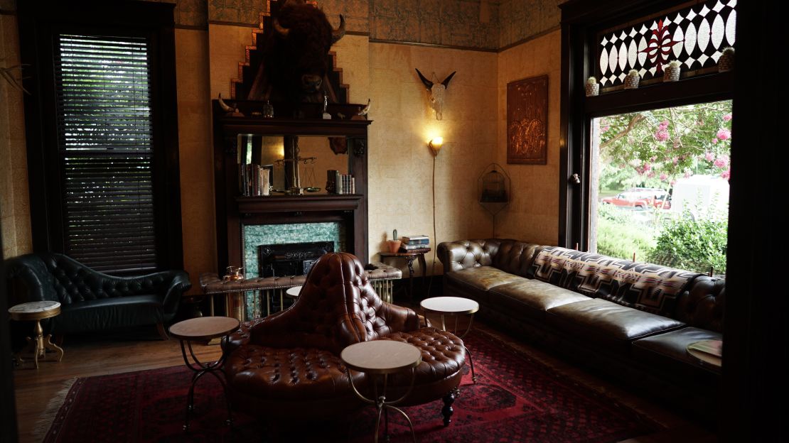 The parlor opposite the room full of musical instruments is impeccably decorated.