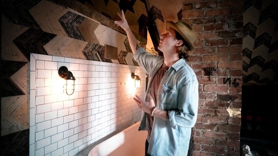 Owner Lyon Porter points out design elements that create 