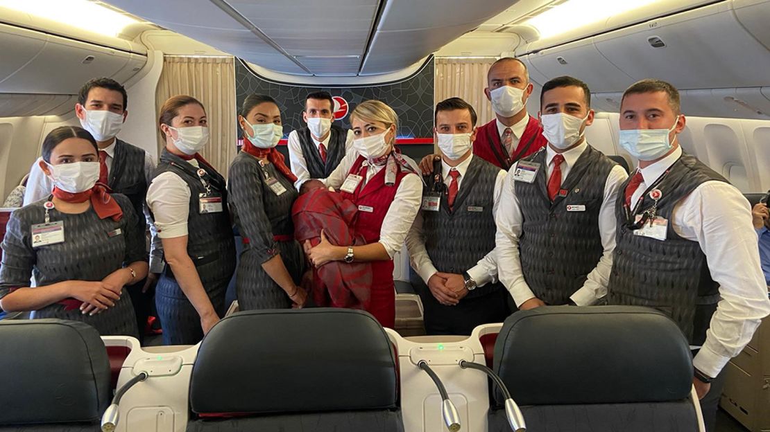 Turkish Airlines crew members with the baby they helped deliver. 