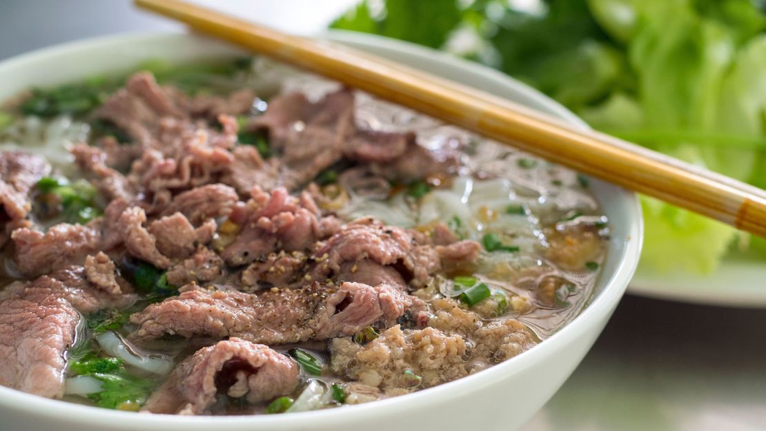 Beef is simmered for hours with cinnamon, star anise and other warm spices to create a wonderfully aromatic base for this rice noodle soup.